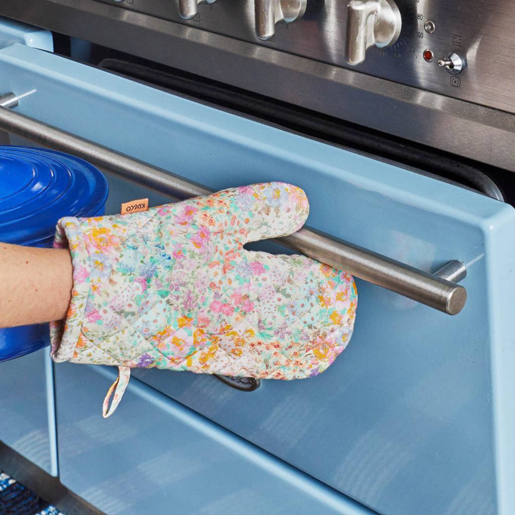 The Kip & Co Little Bit Ditsy Oven Mitt is available for purchase at Cove. Made from 100% cotton, this oven mitt features a charming floral design.