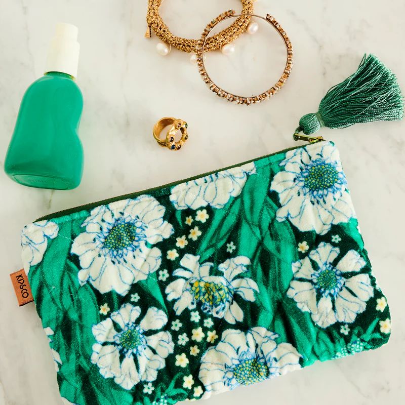 Shop Kip & Co Tumbling Flowers Green Velvet Purse at Cove. This chic and eco-friendly purse features a vibrant floral design on luxurious green velvet, perfect for adding a touch of elegance to any outfit.