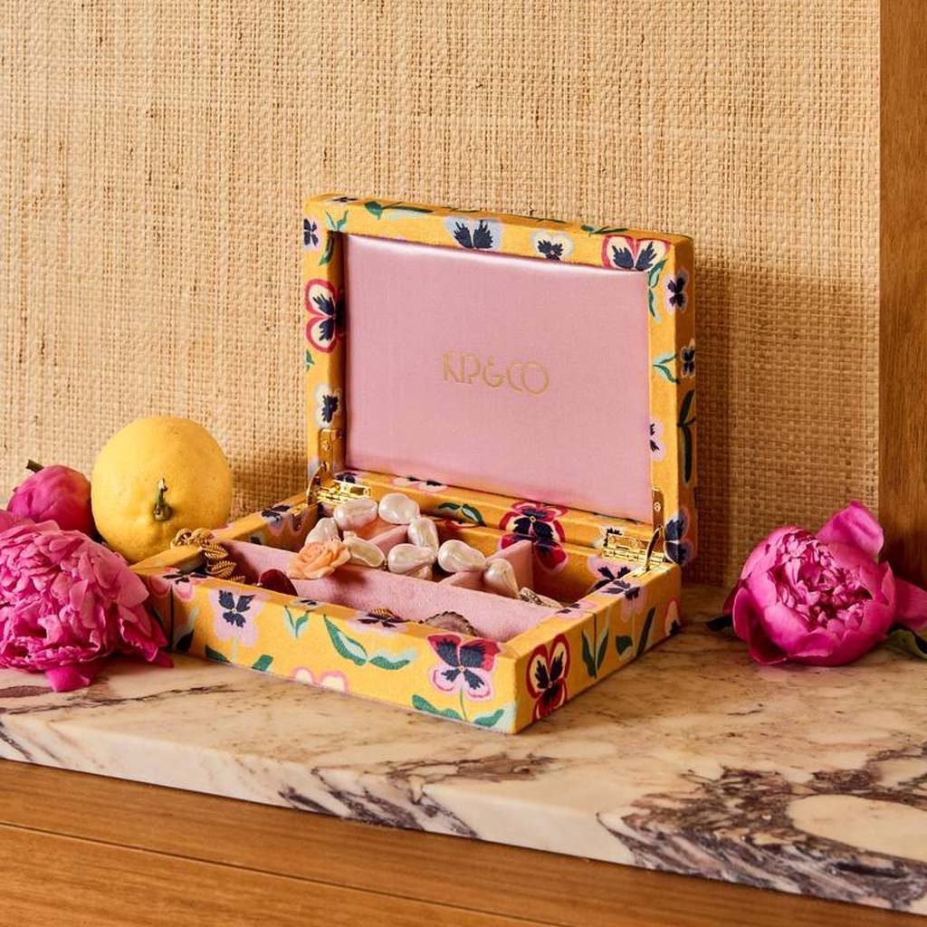 Pretty Pansy jewellery box open on a timber shelf with fruit and flowers