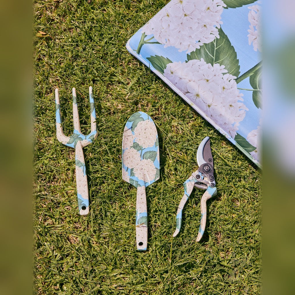 Kip & Co Hydrangea Blue Garden Tools and Gloves Set laid on grass