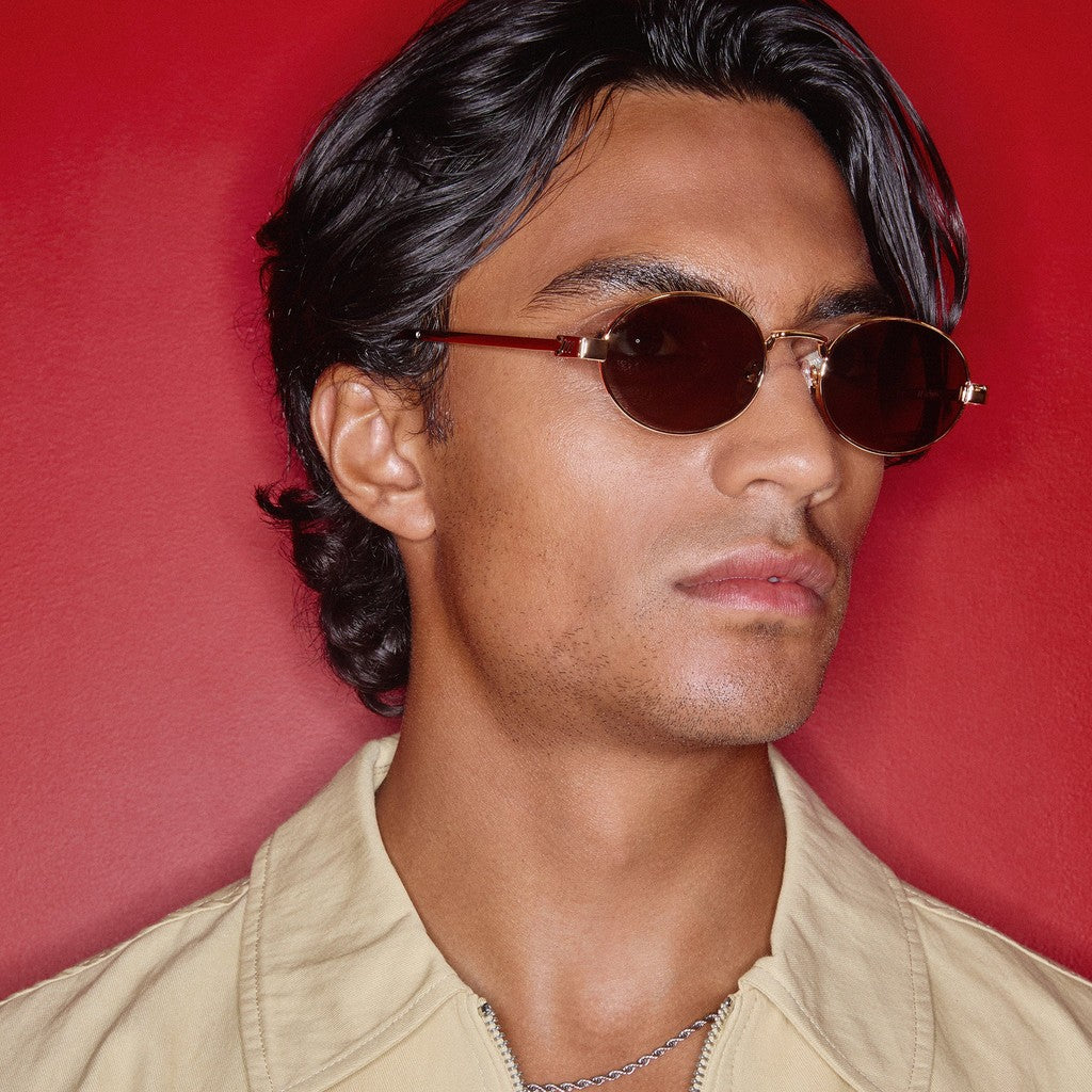 Model wearing Le Specs Poseidon Deux Polarised Gold sunglasses