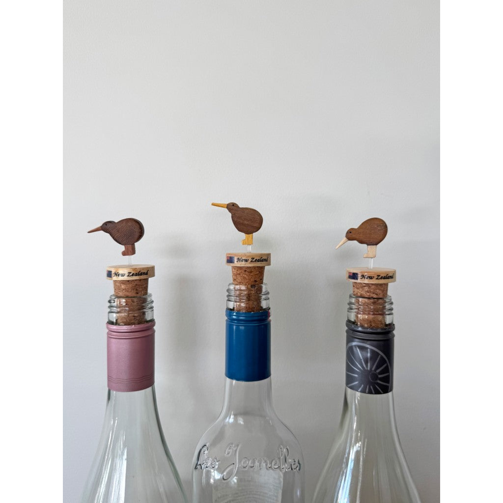 Kiwi bottle corks in three glass bottles