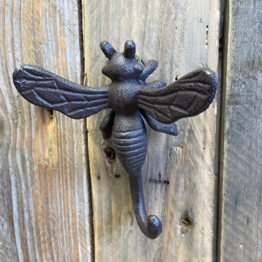 Cast iron bee hook on a weathered fence