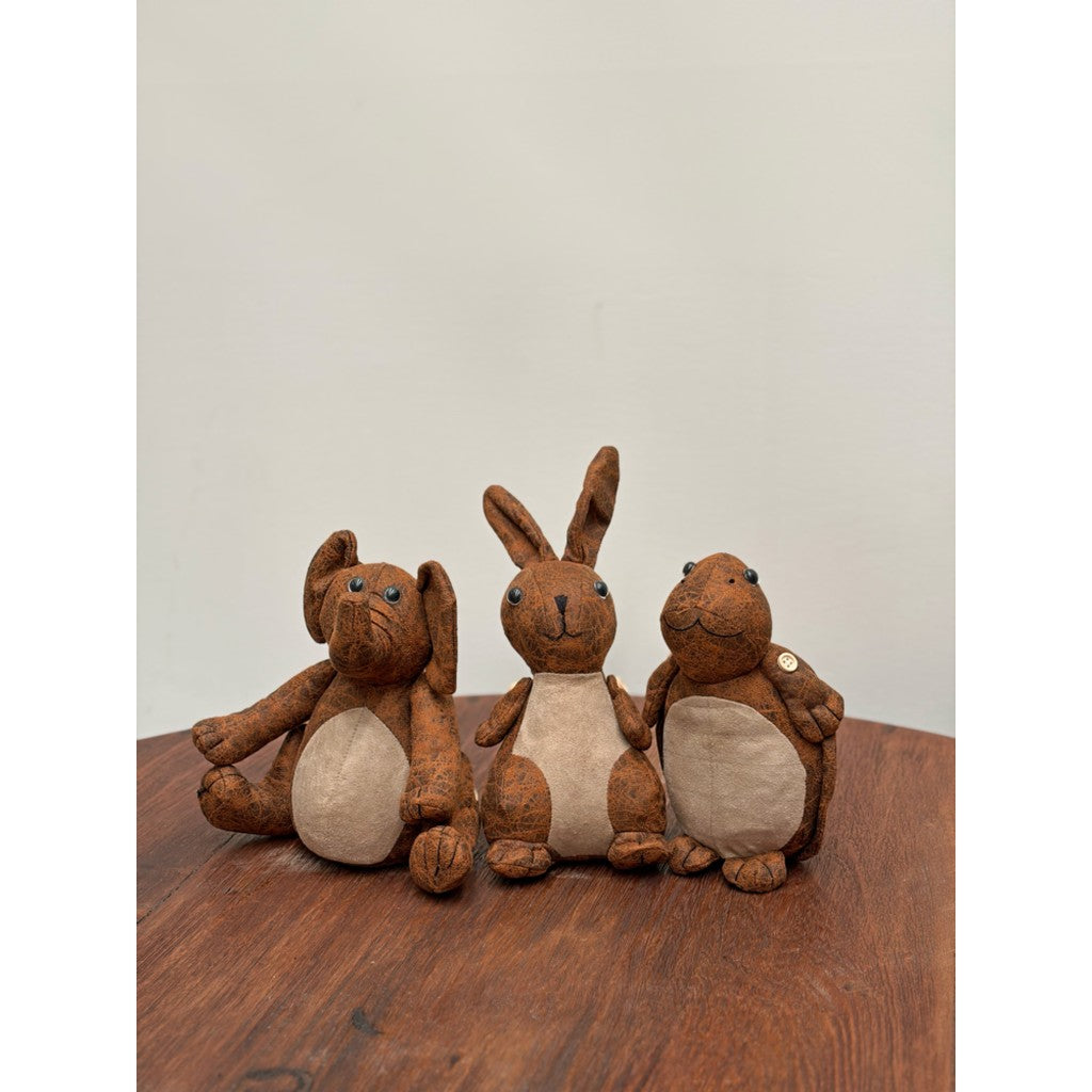 Leather animal doorstops on a timber table