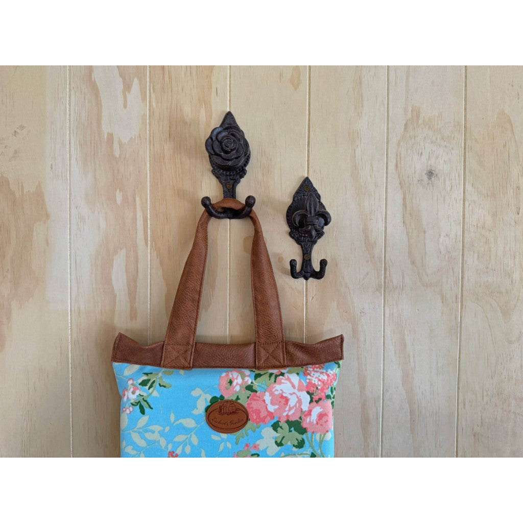 Floral bag hanging from a cast iron flower hook