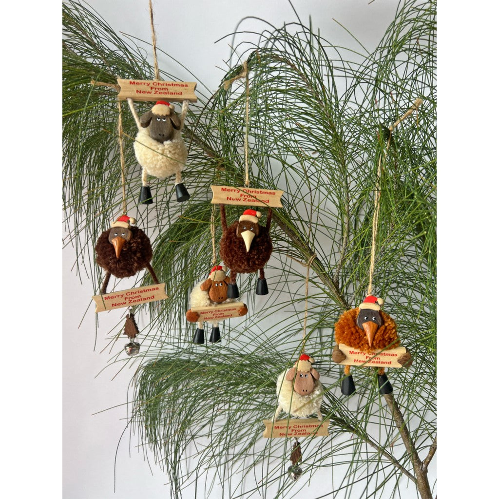Pompom kiwi Christmas ornaments on a pine tree