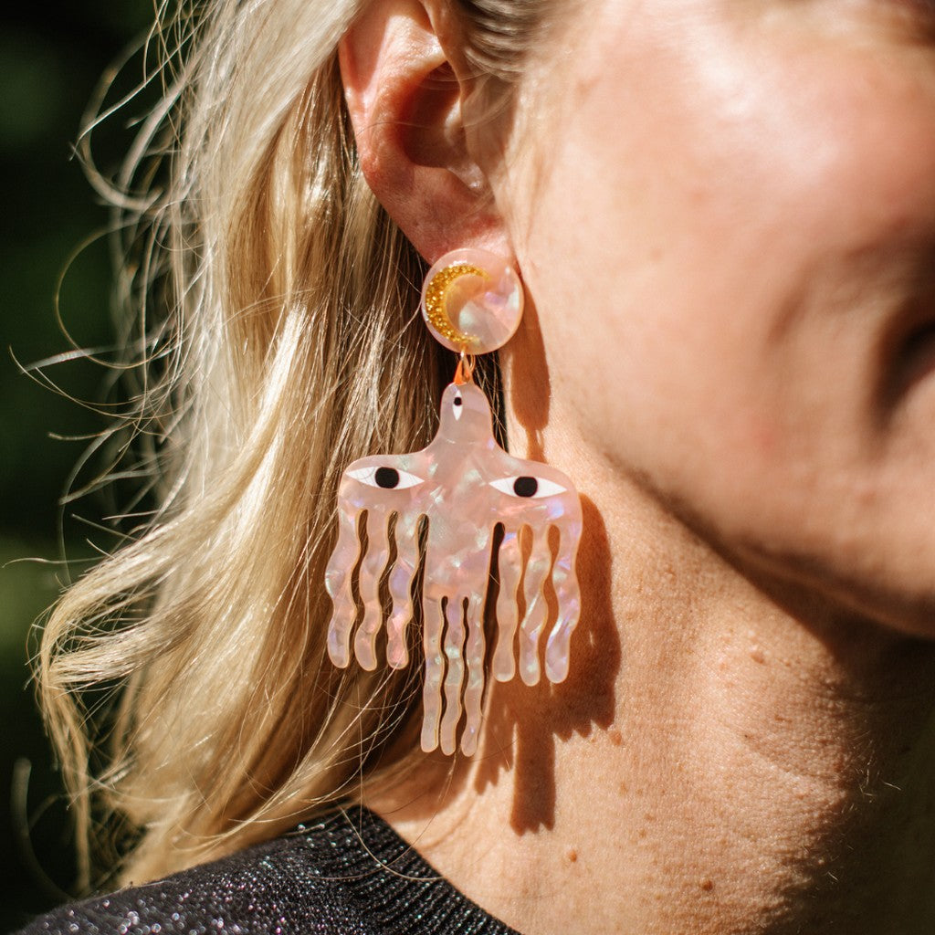 Model wearing Studio Soph Big Birds Galaxy Pink earrings, close-up