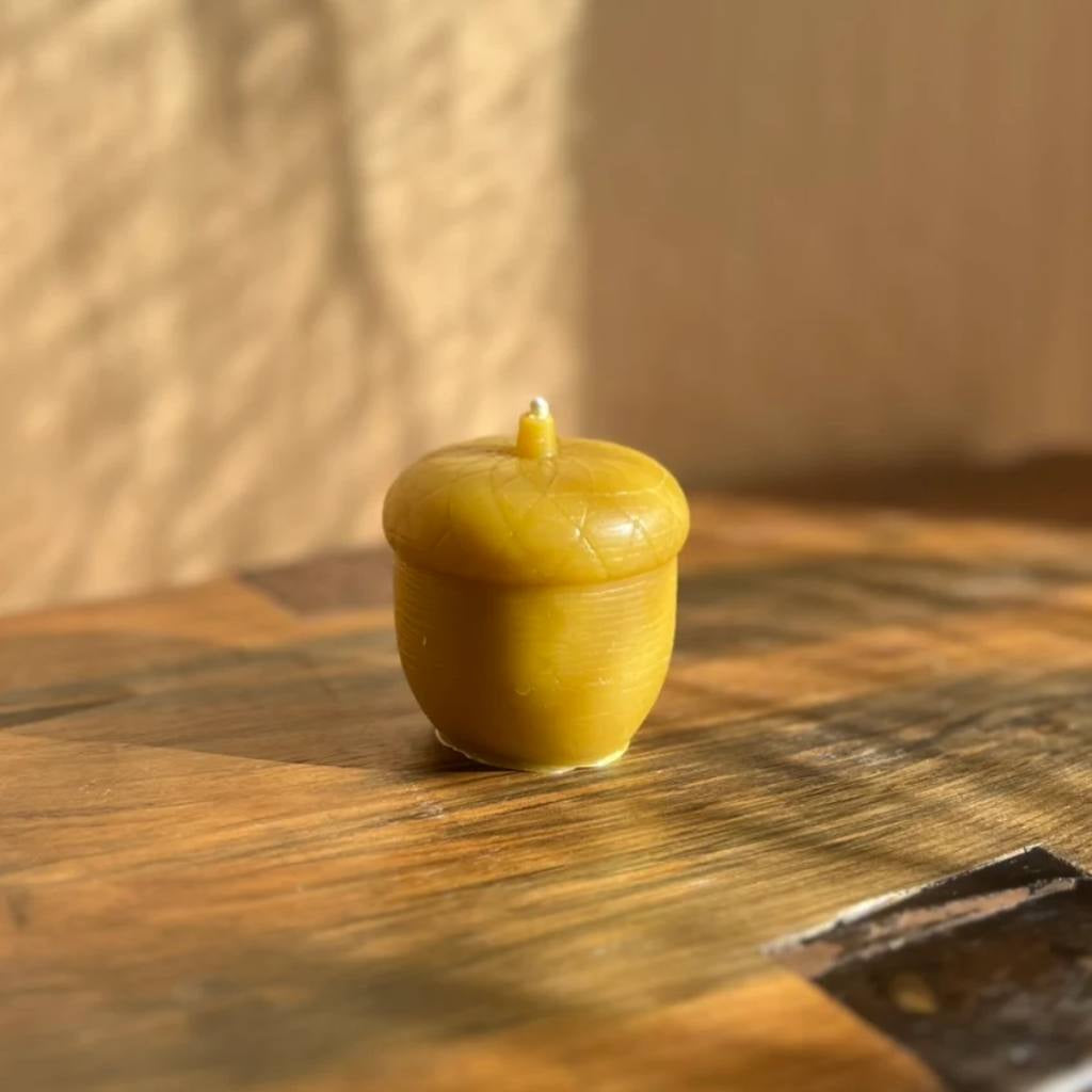 A jar of The Authentic Honey Co. Acorn Natural honey with a rustic label, set against a wooden background. The jar is filled with rich, amber-colored honey, and the label features an illustration of an acorn, emphasizing the natural and organic qualities of the product.