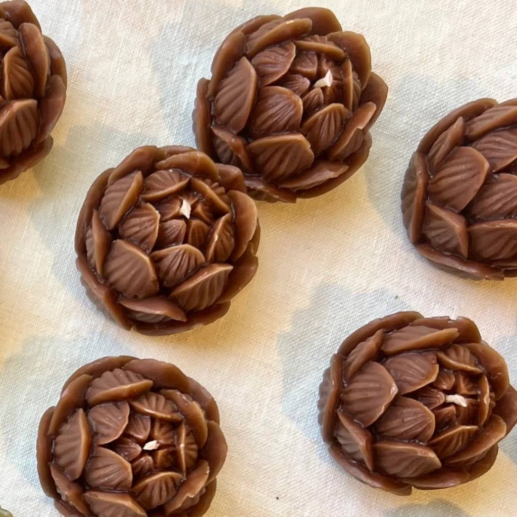 A jar of The Authentic Honey Co. Mini Lotus Amber honey with a golden amber hue, featuring a minimalist label design against a white background.