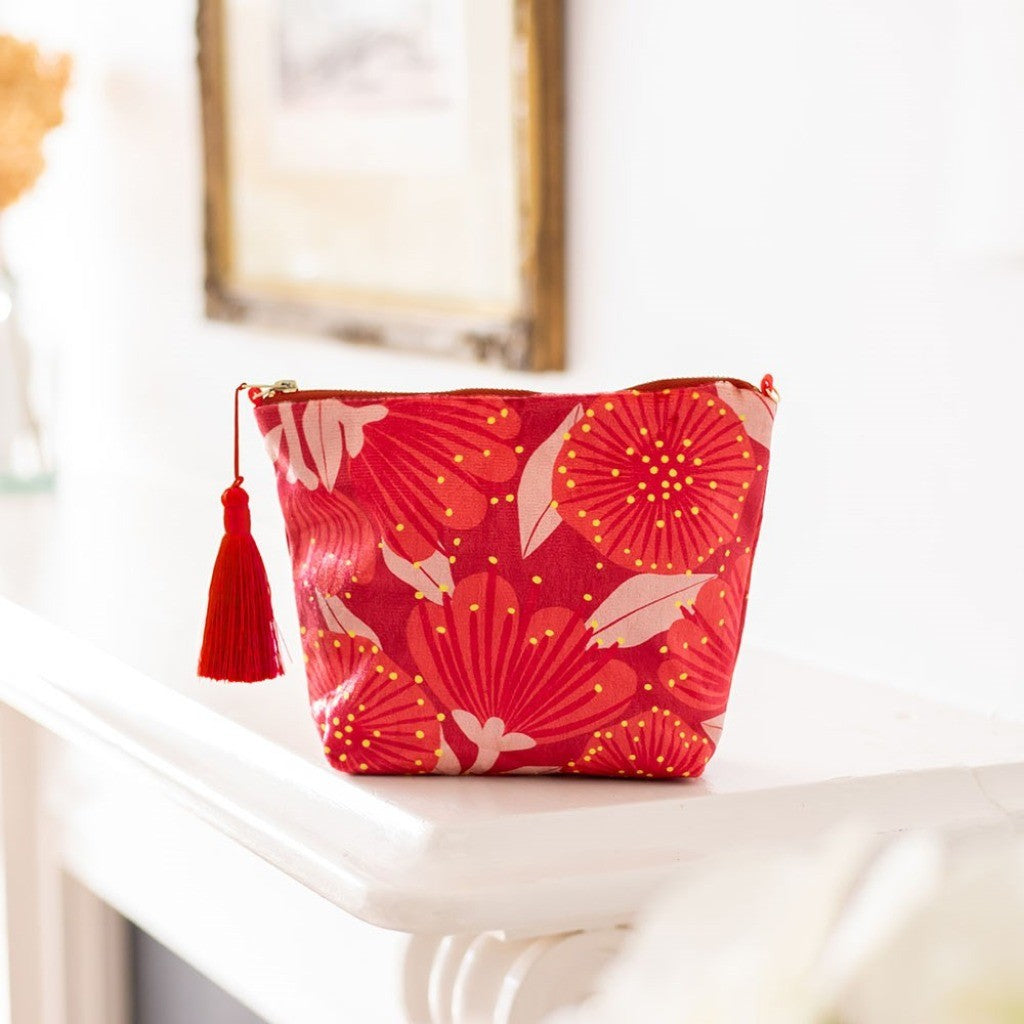 Bright Botanical Pohutukawa Velvet Cosmetic Bag on a shelf