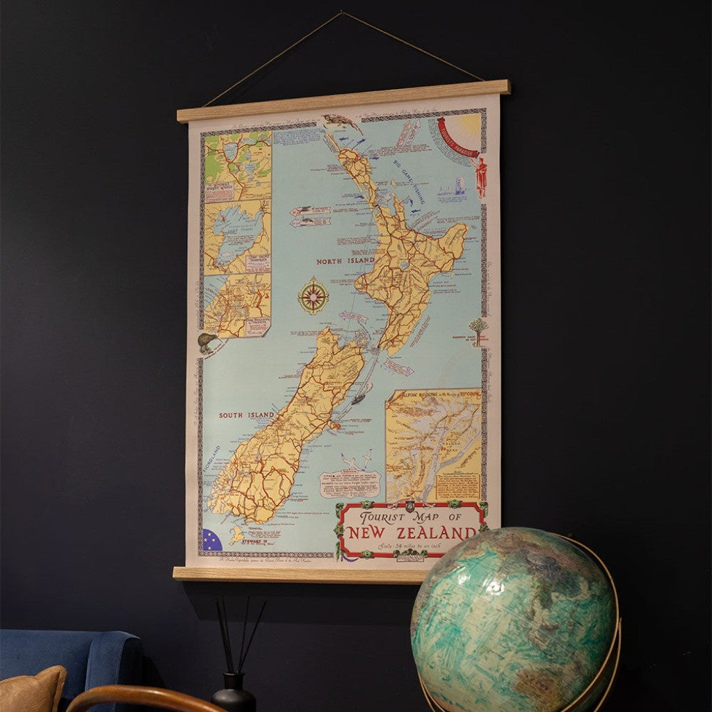 Tourist Map of NZ Wall Chart on a dark wall