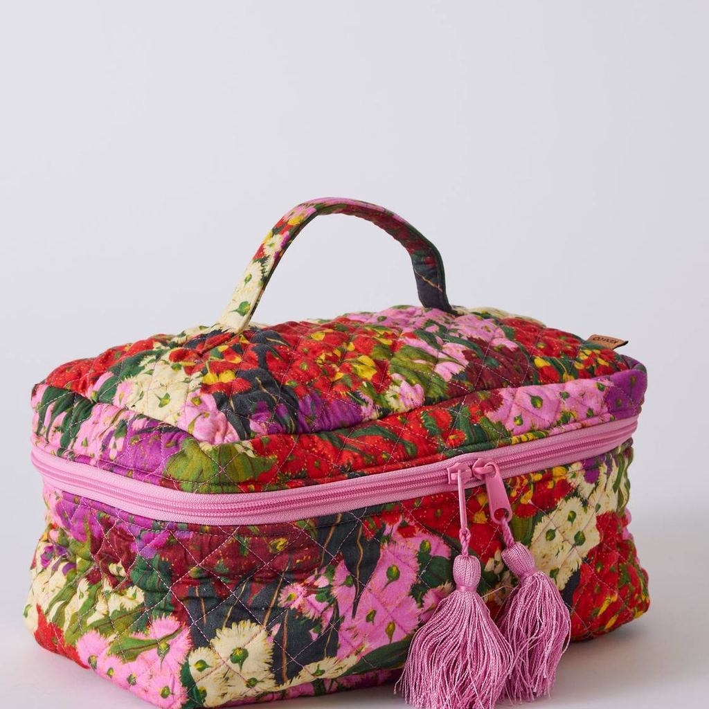 Australian Bush Blossom quilted toiletry case, angled view on grey