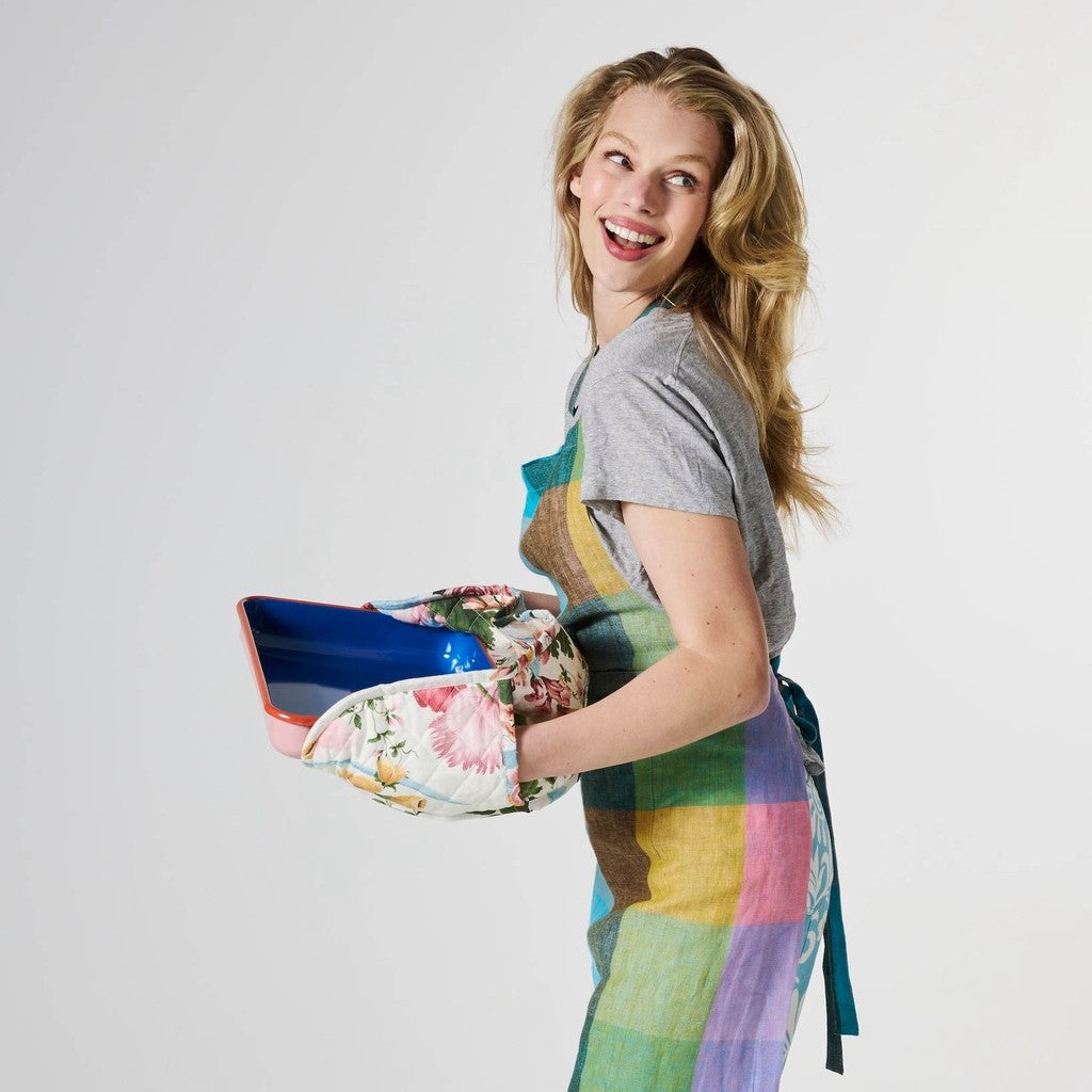 Woman holding a baking dish using the Belle Floral double oven mitt