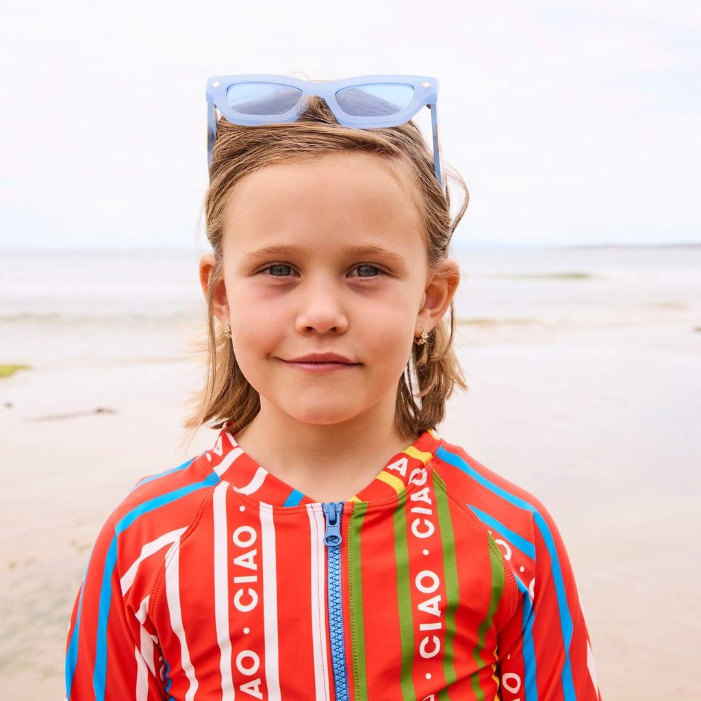 Close-up of girl in Ciao Stripe bathers with sunglasses on her head