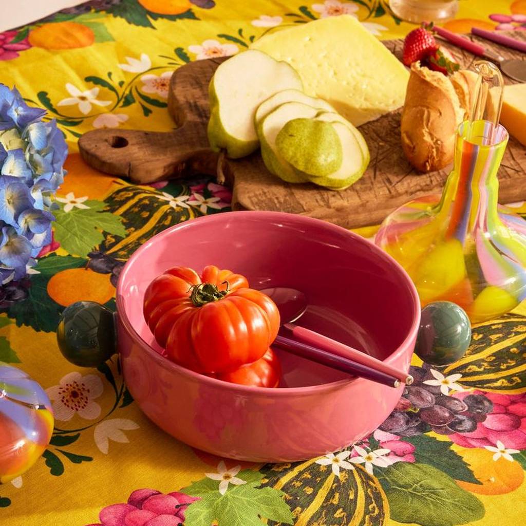 Diner Radiance salad servers in a pink bowl on a yellow floral table