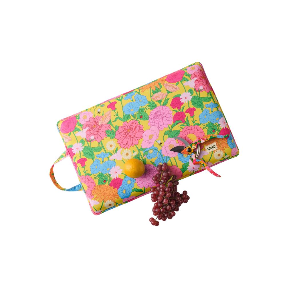 The image is of a garden kneeling mat. It is primarily yellow in color and features a design with the words "Follow The Sun" printed on it. The mat is likely made of a soft, cushioned material to provide comfort while kneeling during gardening tasks. The background of the image is plain, allowing the focus to remain on the kneeling mat itself.