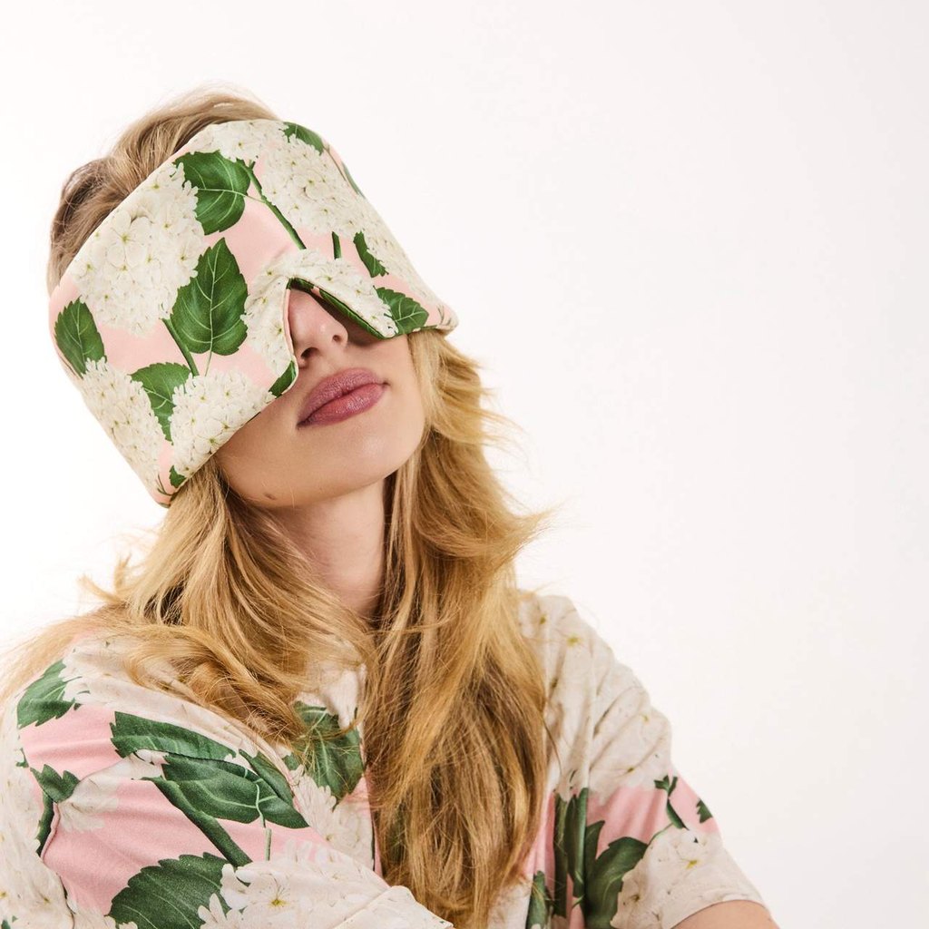 Woman relaxing in the Hydrangea Pink block out eye mask
