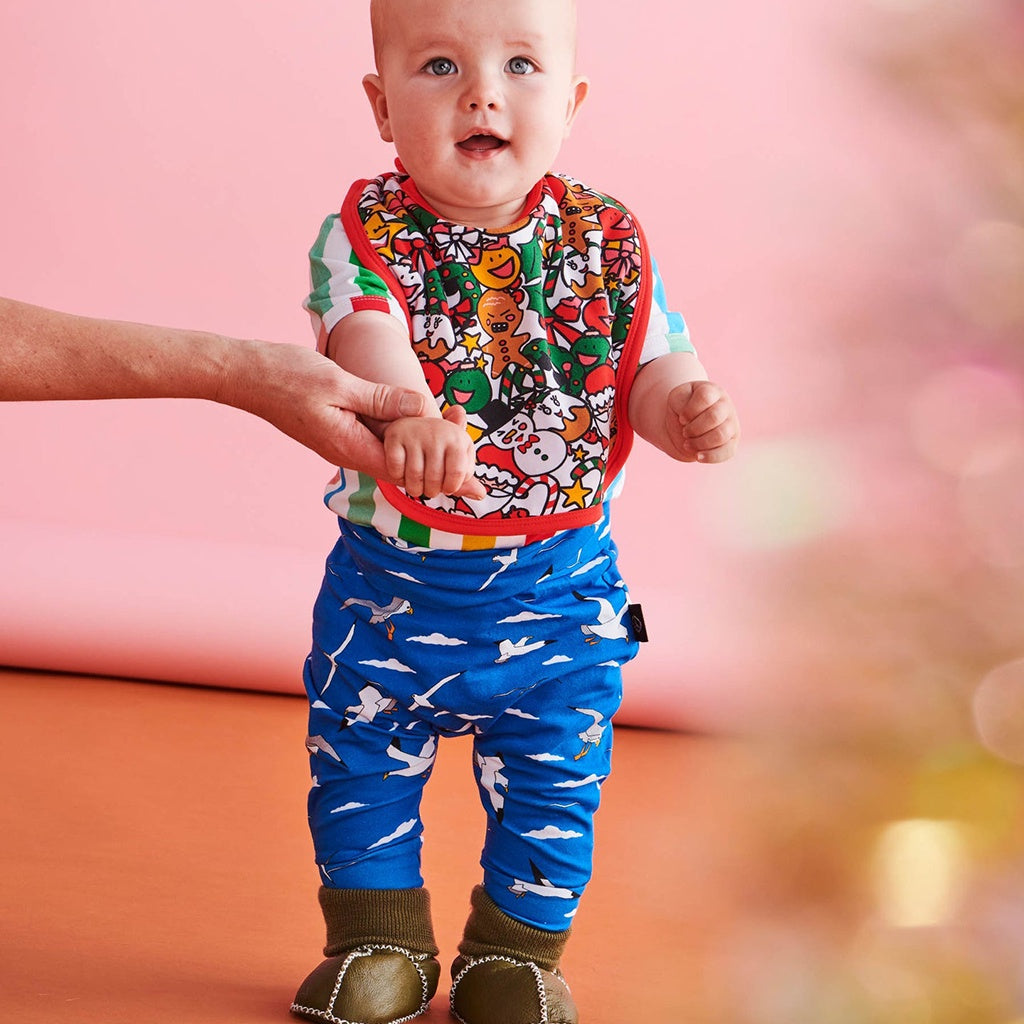 Discover the Kip &amp; Co Christmas Bib at Cove! Made from 100% organic cotton, this reversible bib is perfect for keeping mealtime mess-free while adding a festive touch.