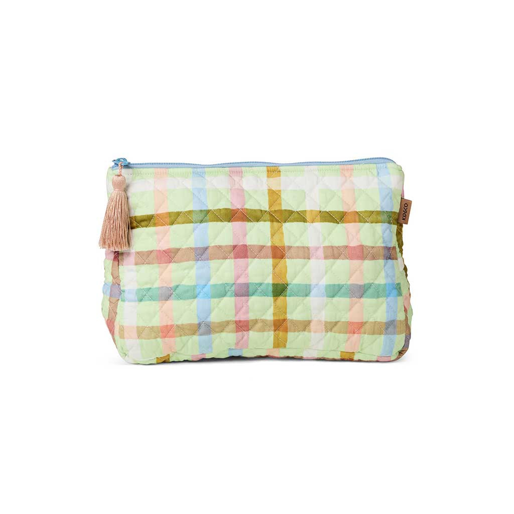 The image is of a quilted cotton toiletry purse from Kip & Co. It features a checkered pattern in pastel colors, primarily mint green and pink, resembling a candy-like appearance. The purse has a zipper closure at the top, and the quilted texture gives it a soft, padded look. The overall design is playful and vibrant, suitable for storing toiletries or small personal items.