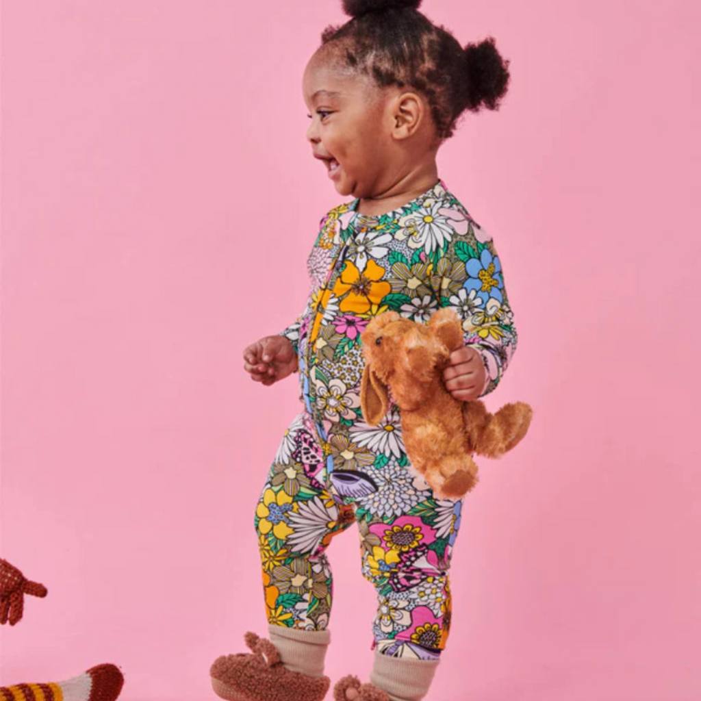 Shop Kip & Co Bliss Floral Romper at Cove: Featuring 70s-inspired florals, this romper is eco-friendly and made from soft materials.