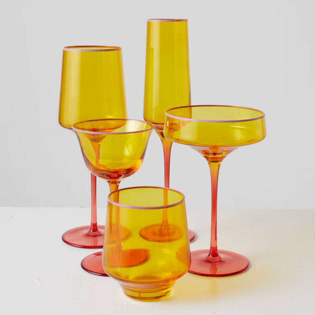 Elevate your cocktail hour with the vibrant and colorful Kip &amp; Co&#39;s Tropical Punch Glass Set, available at Cove. The set features a variety of glasses adorned with tropical-themed designs, perfect for adding a splash of fun and elegance to any gathering.