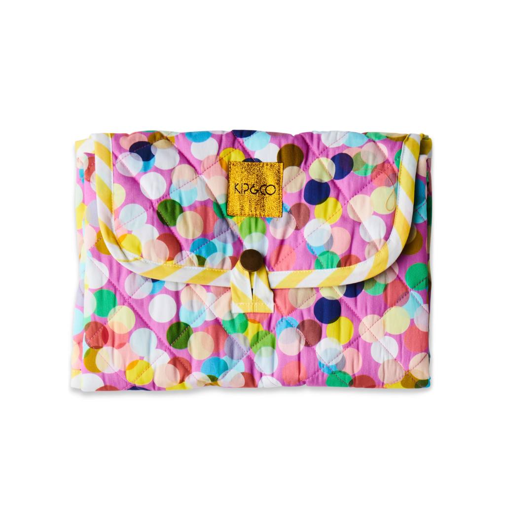 The image likely showcases the Kip & Co Confetti Pink Baby Change Mat available at Cove. The mat features a playful confetti design in pink tones, emphasizing its eco-friendly and stylish appeal.