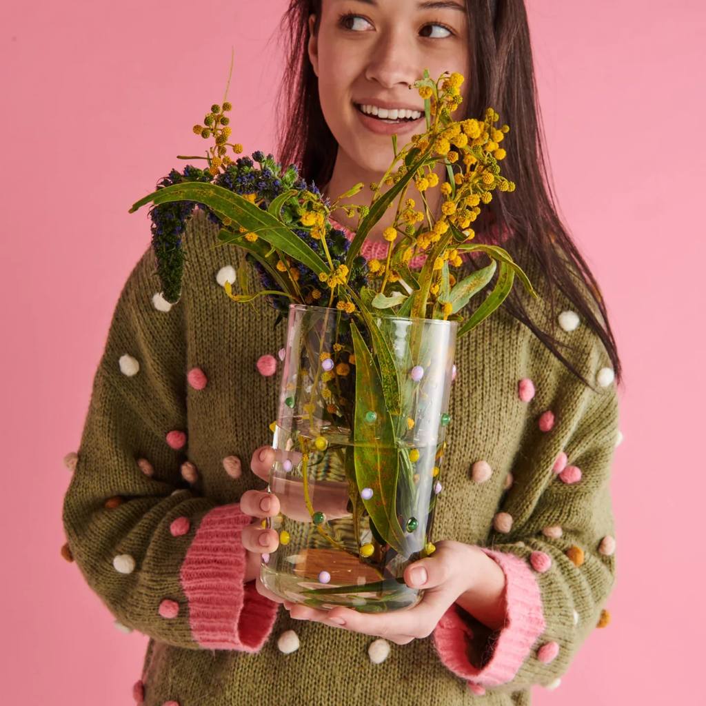 The image shows a colorful handblown vase from Kip & Co, available at Cove. The vase features a playful design with pastel polkadots scattered across its surface, resembling a "Smartie Partie" theme.