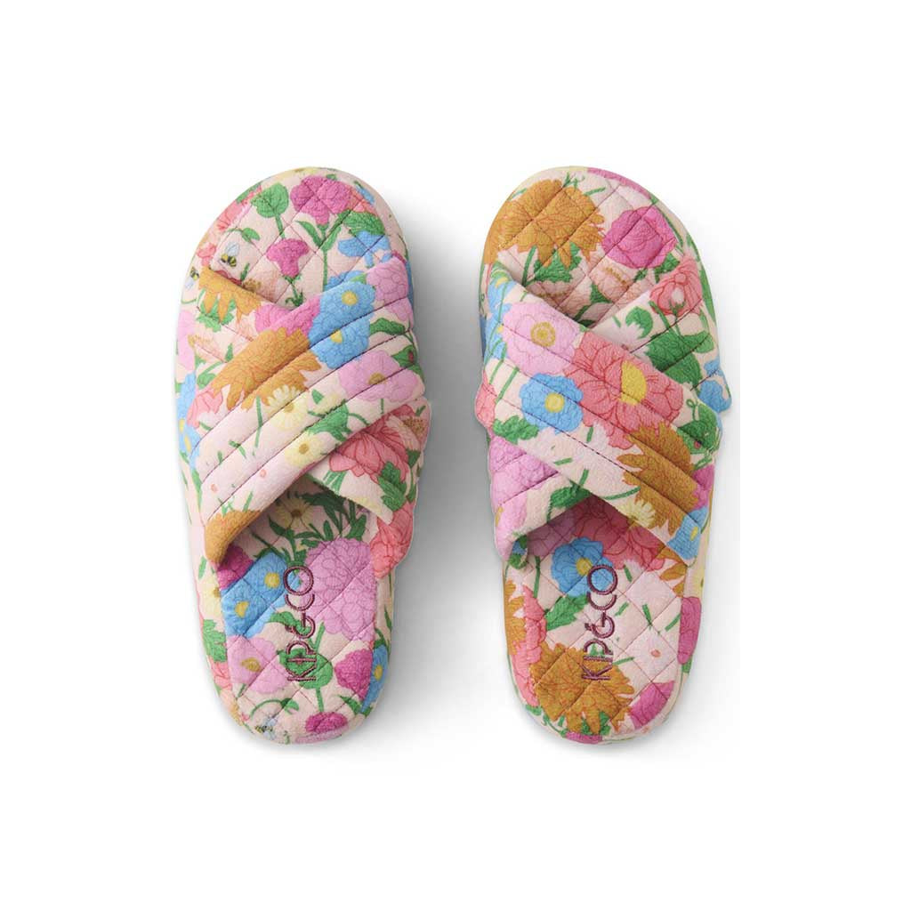 The image shows a pair of adult slippers made from quilted velvet material. The slippers are designed with a soft, plush texture and feature a vibrant, multicolored pattern. The colors include shades of pink, orange, yellow, and blue, arranged in a way that resembles a patchwork or mosaic design. The slippers have a closed-toe style and appear to be cozy and comfortable, suitable for indoor wear. They are displayed against a plain background, highlighting their colorful and luxurious appearance.