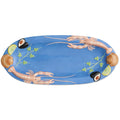 The image is of a large oval platter from Kip & Co, featuring a vibrant and colorful design. The platter is adorned with an artistic depiction of various sea creatures and marine elements, such as fish, shells, and seaweed, all rendered in a playful and whimsical style. The colors are bright and eye-catching, with a mix of blues, greens, reds, and yellows, creating a lively and festive appearance. The platter's design is likely intended to evoke a sense of the ocean and marine life, making it a striking pie