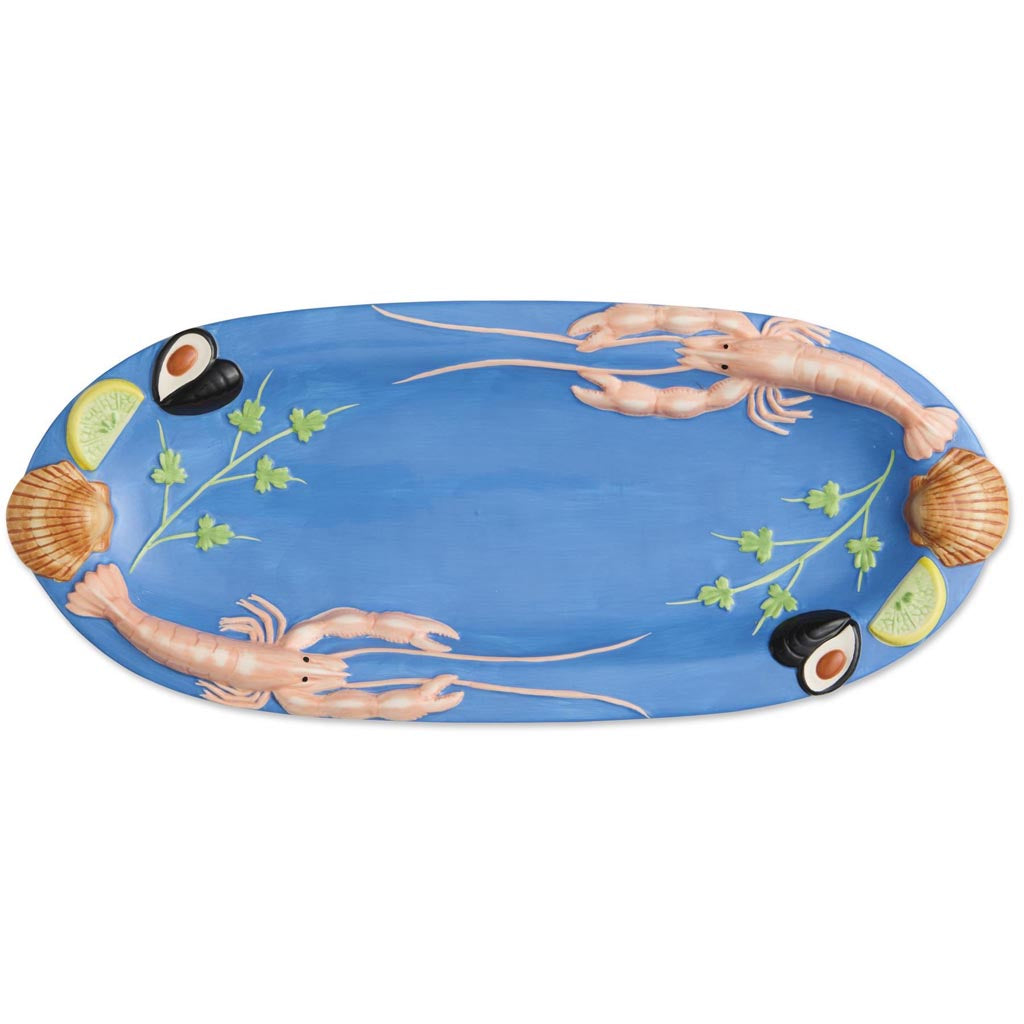 The image is of a large oval platter from Kip & Co, featuring a vibrant and colorful design. The platter is adorned with an artistic depiction of various sea creatures and marine elements, such as fish, shells, and seaweed, all rendered in a playful and whimsical style. The colors are bright and eye-catching, with a mix of blues, greens, reds, and yellows, creating a lively and festive appearance. The platter's design is likely intended to evoke a sense of the ocean and marine life, making it a striking pie