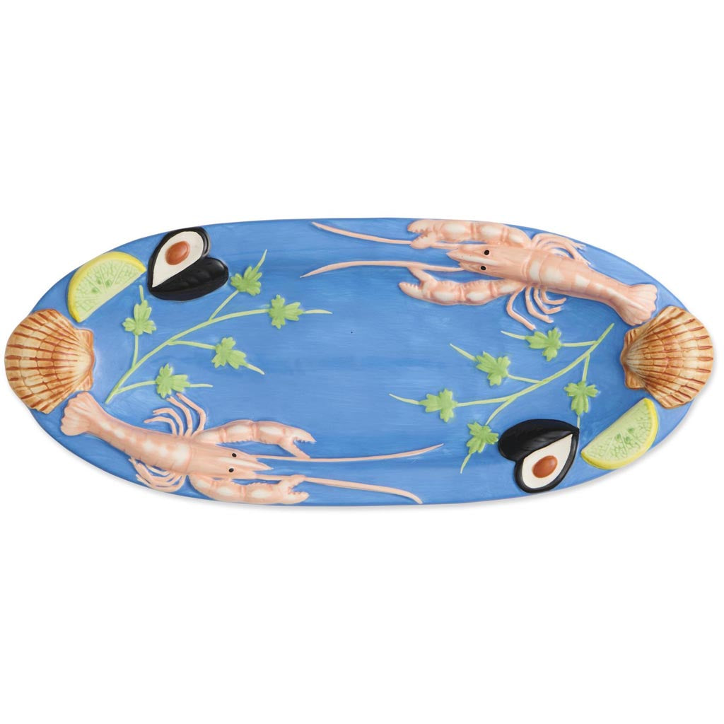 The image is of a small oval platter from Kip & Co, featuring a vibrant and colorful design. The platter is adorned with an artistic depiction of various sea creatures and marine elements, such as fish, shells, and seaweed, all rendered in a playful and whimsical style. The colors are bright and eye-catching, with a mix of blues, greens, reds, and yellows, creating a lively and cheerful appearance. The platter's design is likely intended to evoke a sense of the ocean and marine life, making it a decorative 