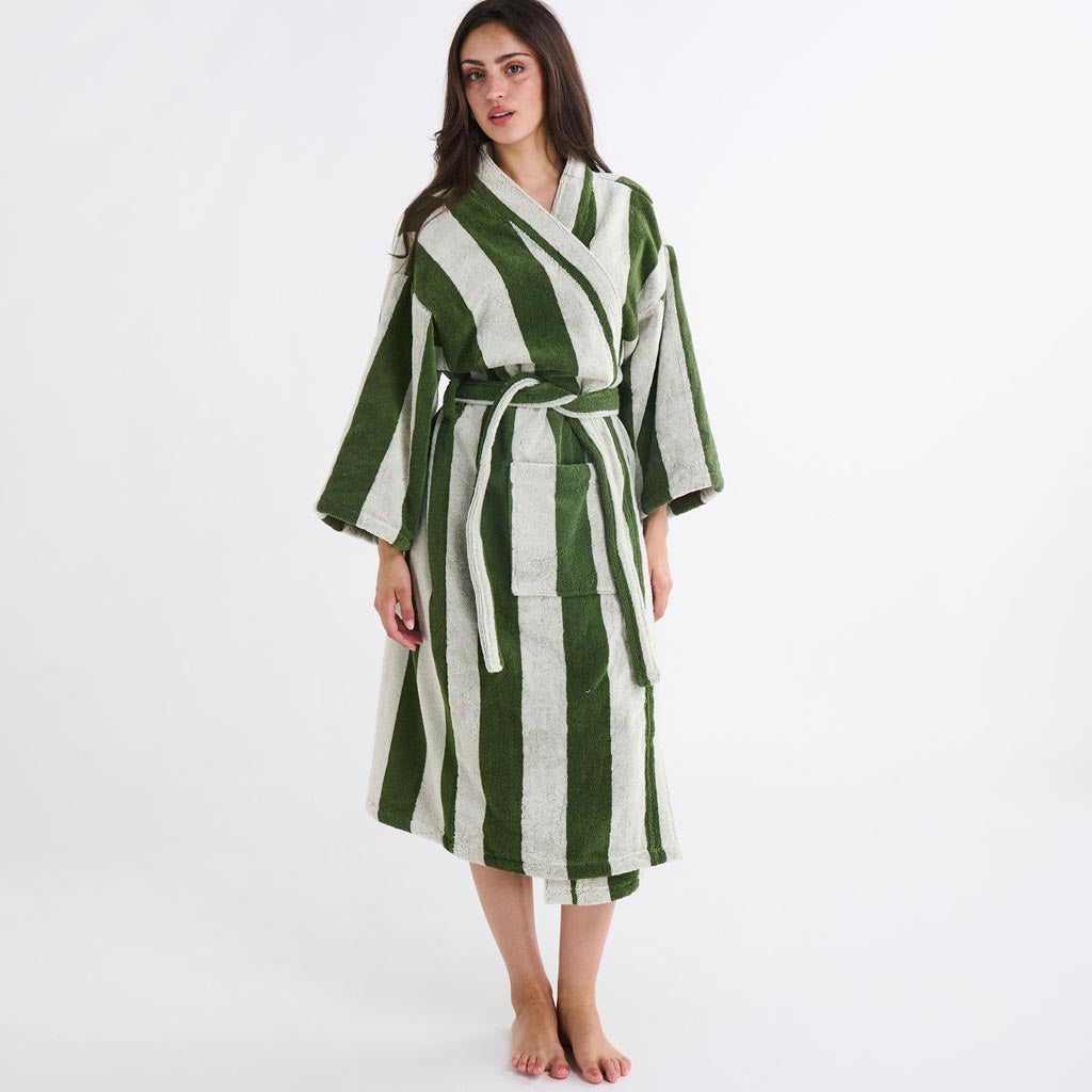 The image is of a bathrobe made from terry cloth material. The robe features a striped pattern with various shades of green, resembling moss. It has a classic design with a shawl collar, long sleeves, and a belt for tying around the waist. The texture appears soft and plush, typical of terry cloth, which is known for its absorbency and comfort. The robe is displayed against a plain background, highlighting its design and color.