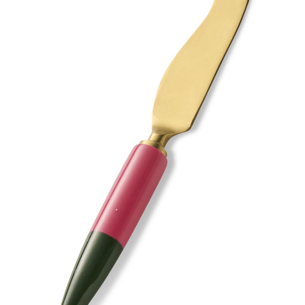 The image shows a cheese knife from the Kip & Co Tuscan Days Brasserie collection. The knife features a sleek and elegant design with a polished metal blade and a handle that appears to be made of a smooth, light-colored material, possibly wood or a synthetic substitute. The handle is ergonomically shaped for a comfortable grip, and the overall aesthetic of the knife is both functional and stylish, suitable for a sophisticated dining setting.