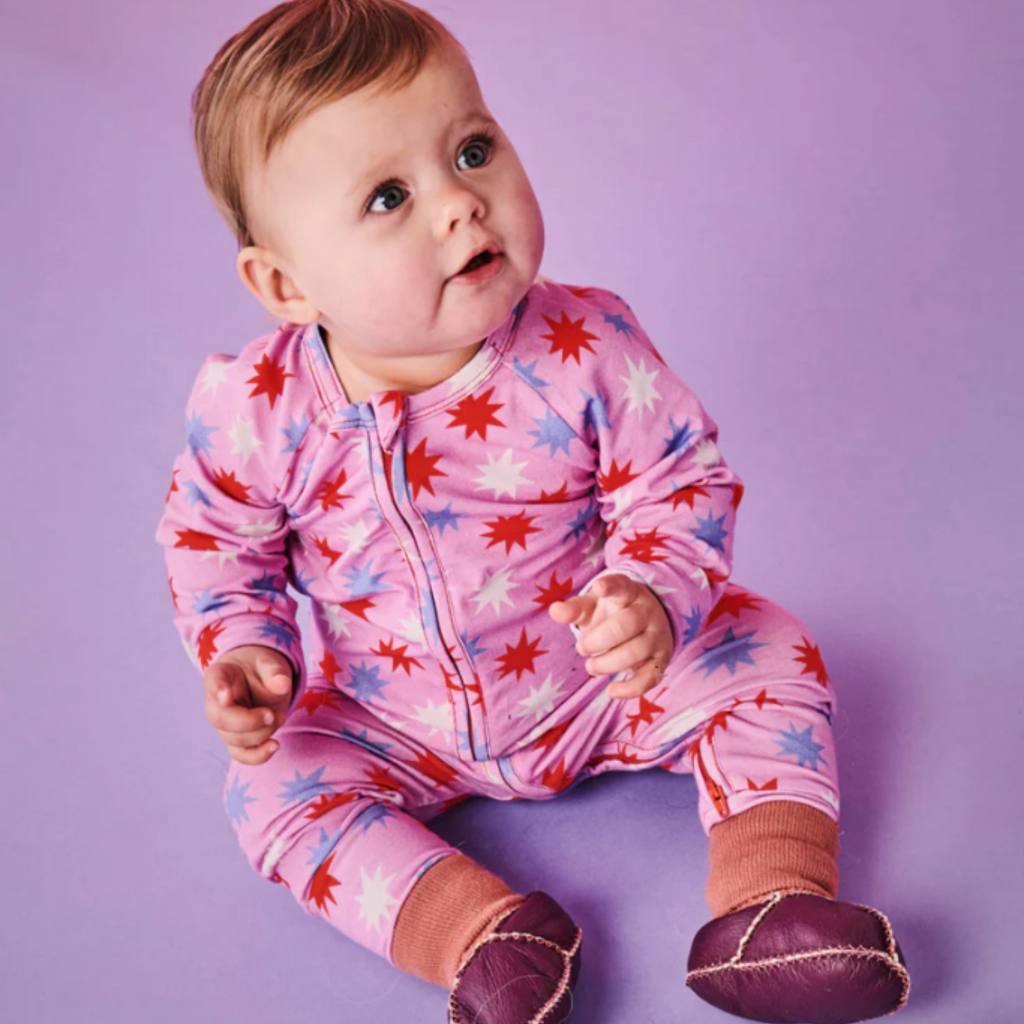 Shop Kip & Co's Be A Star Organic Romper at Cove. This eco-friendly and stylish romper is perfect for your little one. The design features a playful star pattern, ensuring both comfort and cuteness.