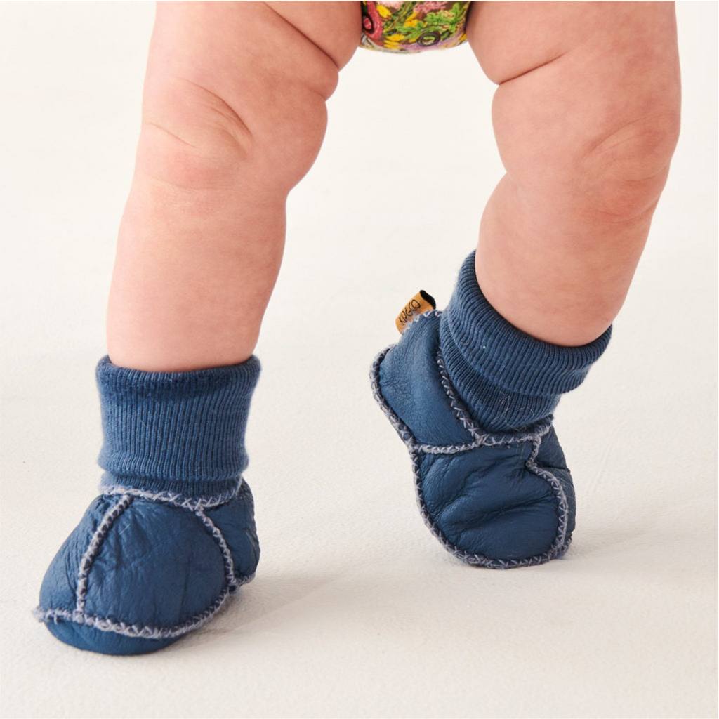 Blue skies baby booties by Kip & Co on white background