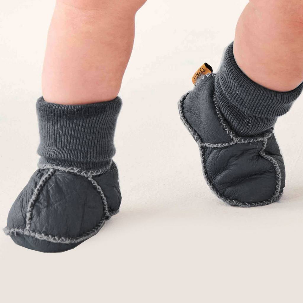 Gray baby socks with sole protection on a white background