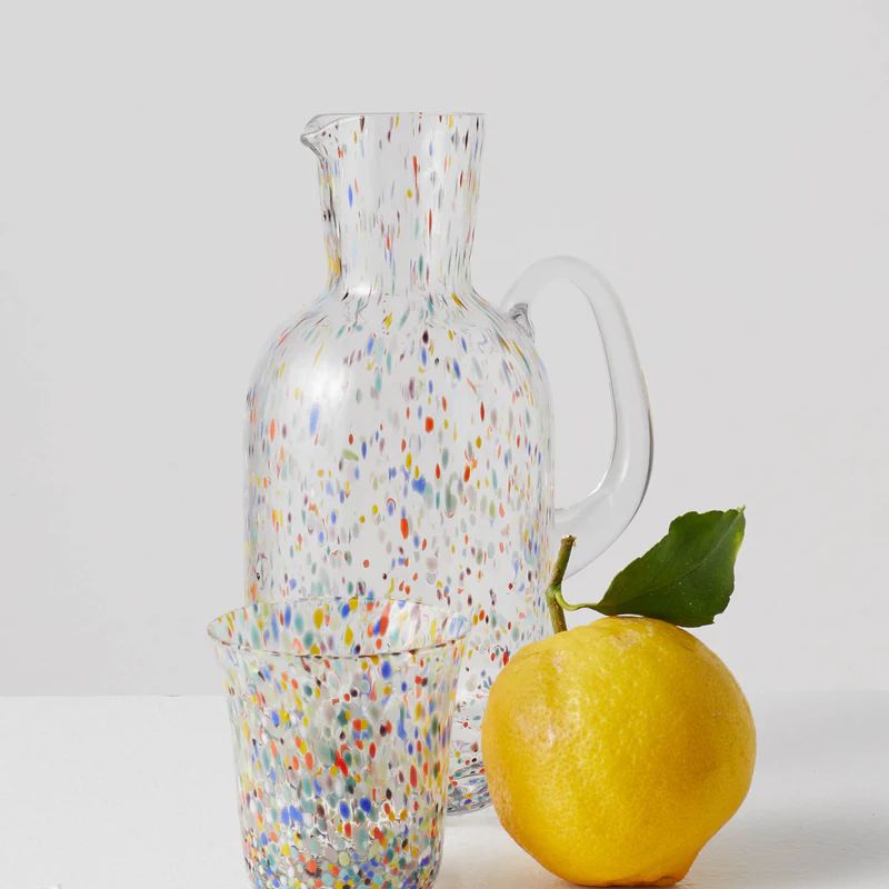 Enhance your parties with Kip & Co's Party Speckle Jug available at Cove. This handblown jug is vibrant and has a capacity of 1.7 liters, making it perfect for serving drinks in style.