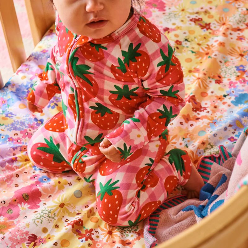 The image likely shows a Kip & Co Strawberry Jam Organic Romper, which is available for purchase at Cove. The romper is described as soft, eco-friendly, and comfortable, making it an appealing choice for those looking for sustainable and cozy clothing options.