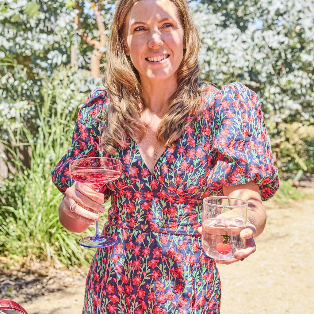 The image shows a set of two margarita glasses from Kip & Co. Each glass features a unique design with a blue robin motif. The glasses are elegantly shaped with a wide, shallow bowl and a sturdy stem, typical of margarita glasses. The blue robin design adds a touch of whimsy and color, making these glasses both functional and decorative. They are likely displayed on a neutral background to highlight their intricate design and vibrant colors.