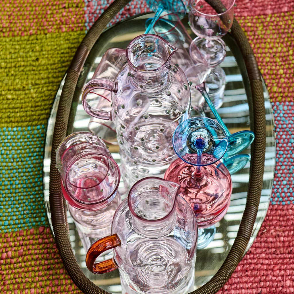 The image shows a set of two margarita glasses from Kip & Co. Each glass features a unique design with a blue robin motif. The glasses are elegantly shaped with a wide, shallow bowl and a sturdy stem, perfect for serving margaritas or other cocktails. The blue robin design adds a touch of whimsy and color, making these glasses a stylish addition to any glassware collection.