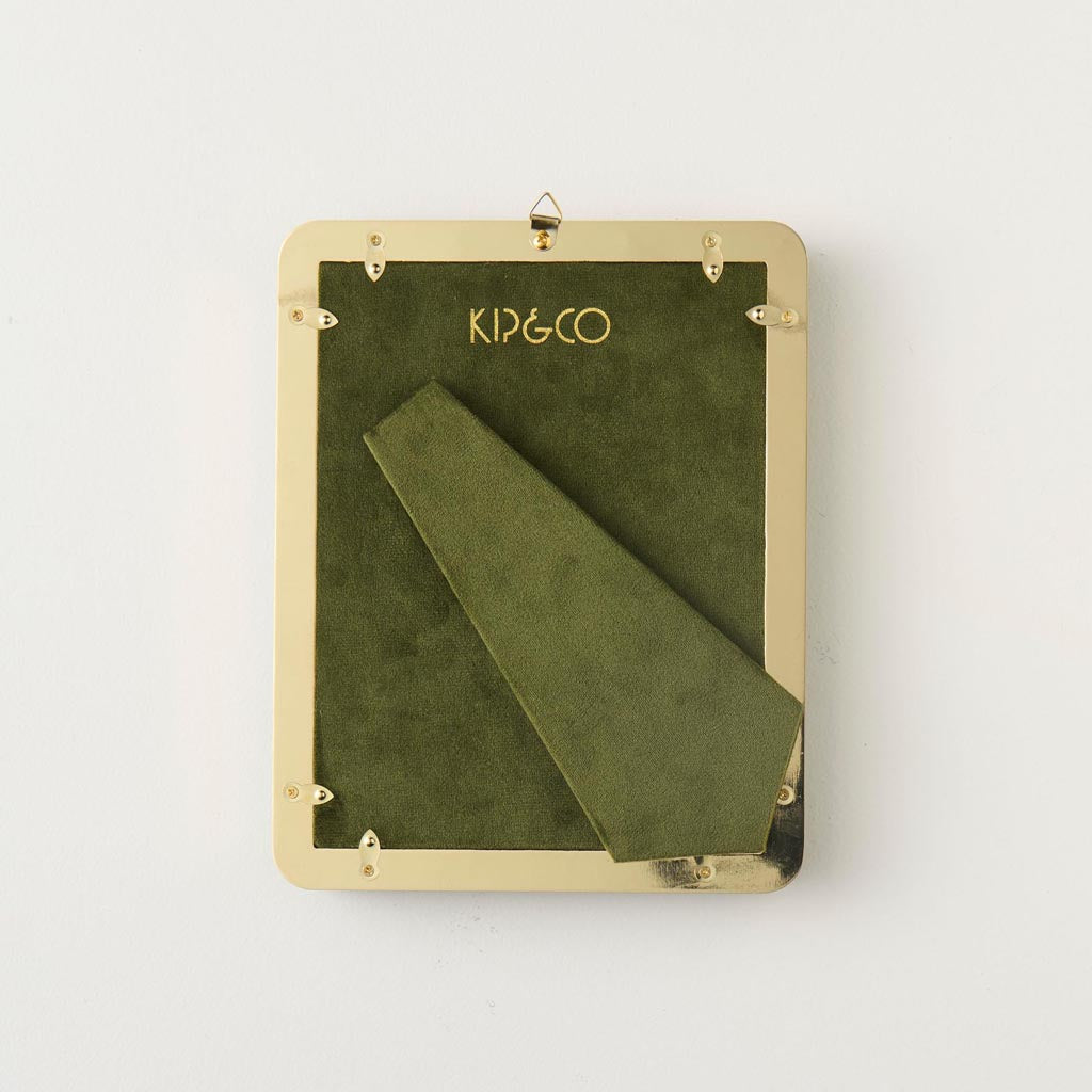 The image is of a square photo frame made from velvet material. The frame is designed with a vibrant and colorful pattern featuring various abstract shapes and colors, giving it a lively and artistic appearance. The center of the frame is cut out to hold a 6 x 6 inch photo. The frame's texture appears soft and plush, typical of velvet, adding a touch of elegance and luxury to its overall look.