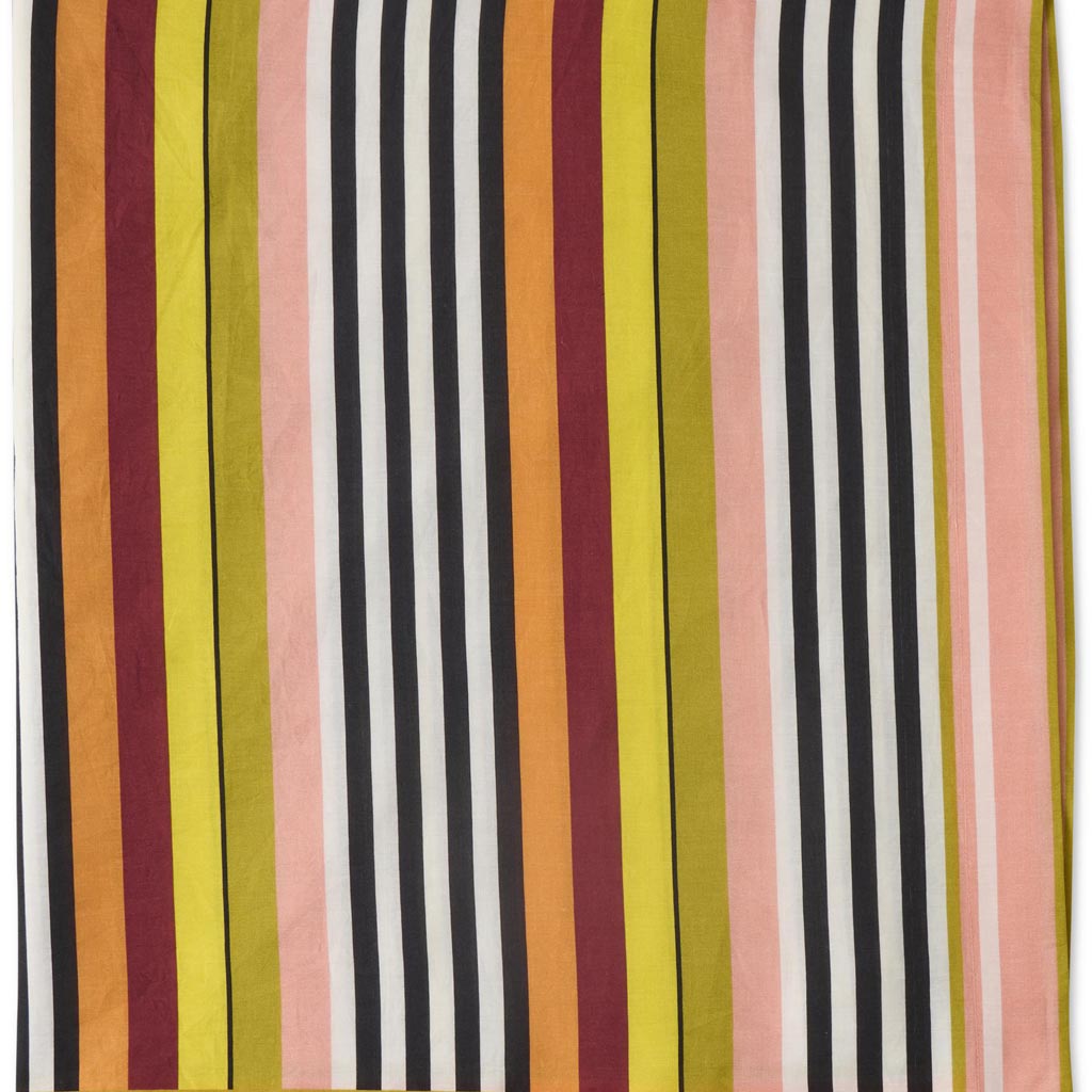 The image is of a colorful striped sarong made from organic cotton. The sarong features a vibrant pattern with horizontal stripes in various colors, including shades of pink, orange, yellow, green, and blue. The fabric appears lightweight and soft, suitable for use as a beach cover-up or a versatile accessory. The sarong is displayed against a plain background, highlighting its bold and lively design.