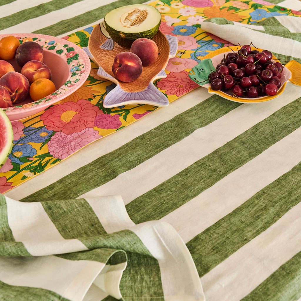 The image is of a decorative serving dish shaped like a fish. The dish is likely made of ceramic or a similar material and features a colorful, intricate design. The body of the fish is adorned with vibrant patterns and hues, possibly inspired by tropical or oceanic themes. The dish is designed to be both functional and aesthetically pleasing, suitable for serving food or as a decorative piece in a home setting.