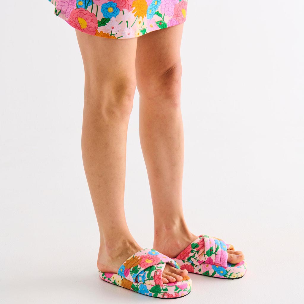 The image shows a pair of adult slippers made from quilted velvet material. The slippers are designed with a cozy and plush appearance, featuring a soft, textured surface. They are likely in a warm, inviting color, possibly with a subtle pattern or stitching detail that adds to their luxurious look. The slippers have a rounded toe and a comfortable, cushioned sole, making them ideal for indoor wear. The overall design suggests a focus on comfort and style, perfect for keeping feet warm and snug.