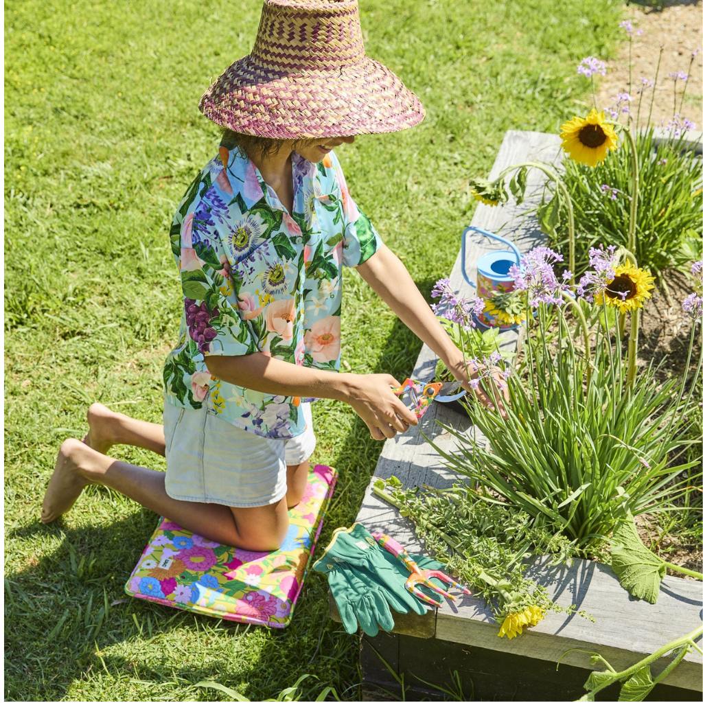 The image shows a gardening set consisting of a pair of yellow garden secateurs and matching gloves. The secateurs have a sleek design with a bright yellow handle, while the gloves are made from a durable material, also in a vibrant yellow color, with a textured grip on the palms and fingers for better handling. The set is displayed on a plain background, highlighting the cheerful and coordinated design of the tools.