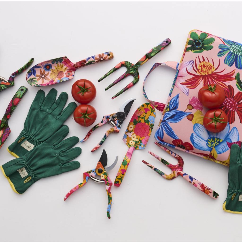The image shows a gardening set consisting of a pair of yellow garden secateurs and a pair of gloves. The secateurs have a sleek design with a bright yellow handle, which is likely made of a durable material for comfortable grip and efficient cutting. The gloves are designed for gardening use, featuring a colorful pattern that may include floral or abstract designs, adding a touch of style to their functionality. The background is likely neutral to highlight the vibrant colors of the gardening tools.