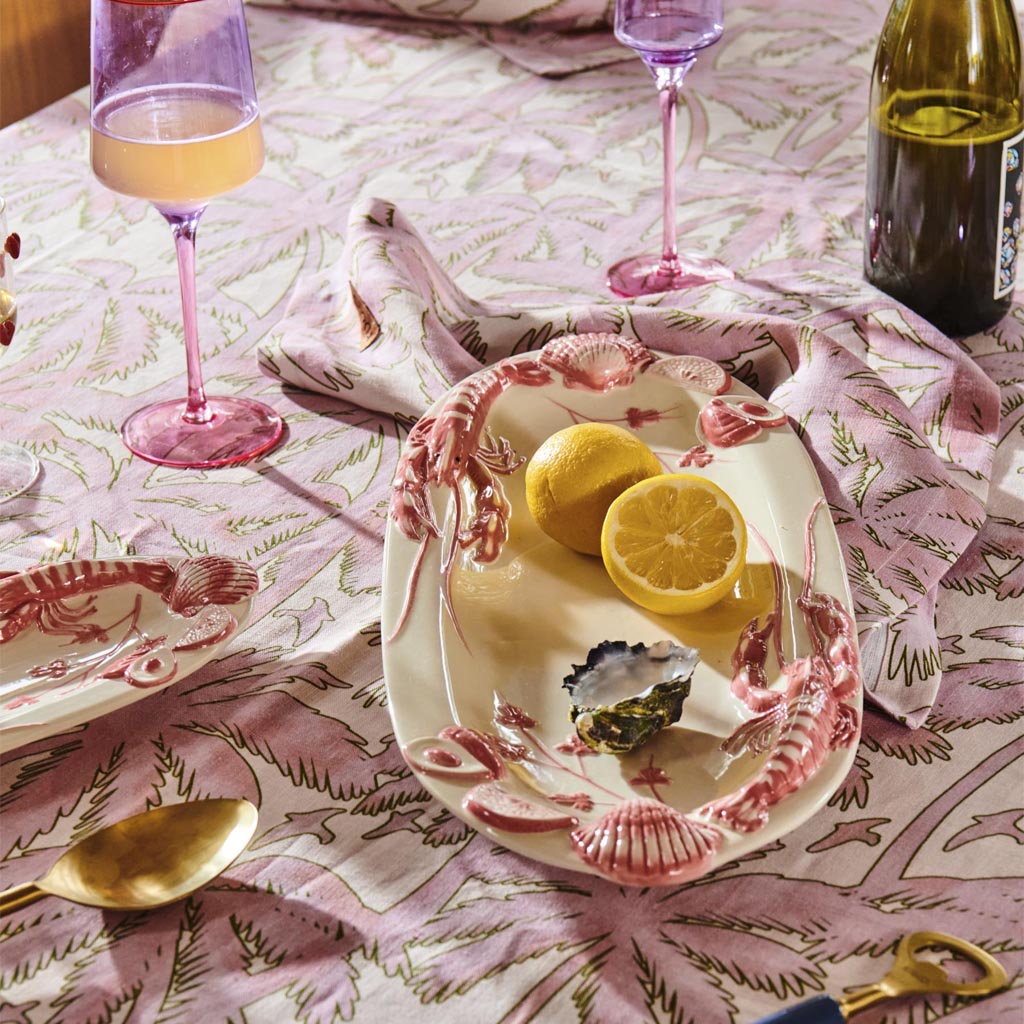 The image shows a pair of elegant wine glasses with a unique color block design. Each glass features a lilac-colored stem and base, while the bowl of the glass is clear, allowing the wine's color to be visible. The glasses are set against a plain background, highlighting their modern and stylish appearance. The design is both functional and decorative, making these glasses suitable for both casual and formal settings.