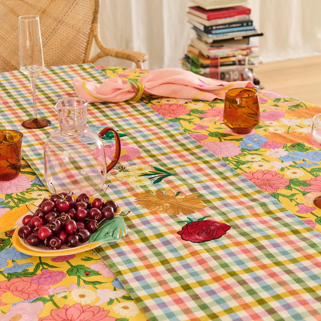The image shows a set of two champagne glasses from Kip & Co. Each glass features a unique and colorful design, with one glass predominantly showcasing a marshmallow-like pattern and the other a marmalade-inspired design. The glasses are elegantly shaped, with a slender stem and a wide, shallow bowl, typical of champagne glasses. The vibrant colors and artistic patterns give the set a playful and modern aesthetic, making them stand out as a stylish addition to any table setting.