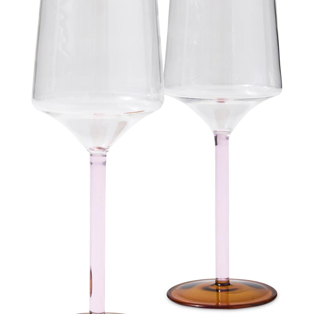 The image shows a set of two wine glasses from Kip & Co, named "Marshmallow and Marmalade Vino Glass 2P Set." The glasses are likely designed with a colorful and artistic pattern, possibly featuring hues reminiscent of marshmallows and marmalade, such as soft pinks, oranges, and other vibrant colors. The glasses are elegantly shaped, suitable for serving wine, and are displayed against a plain background to highlight their design.