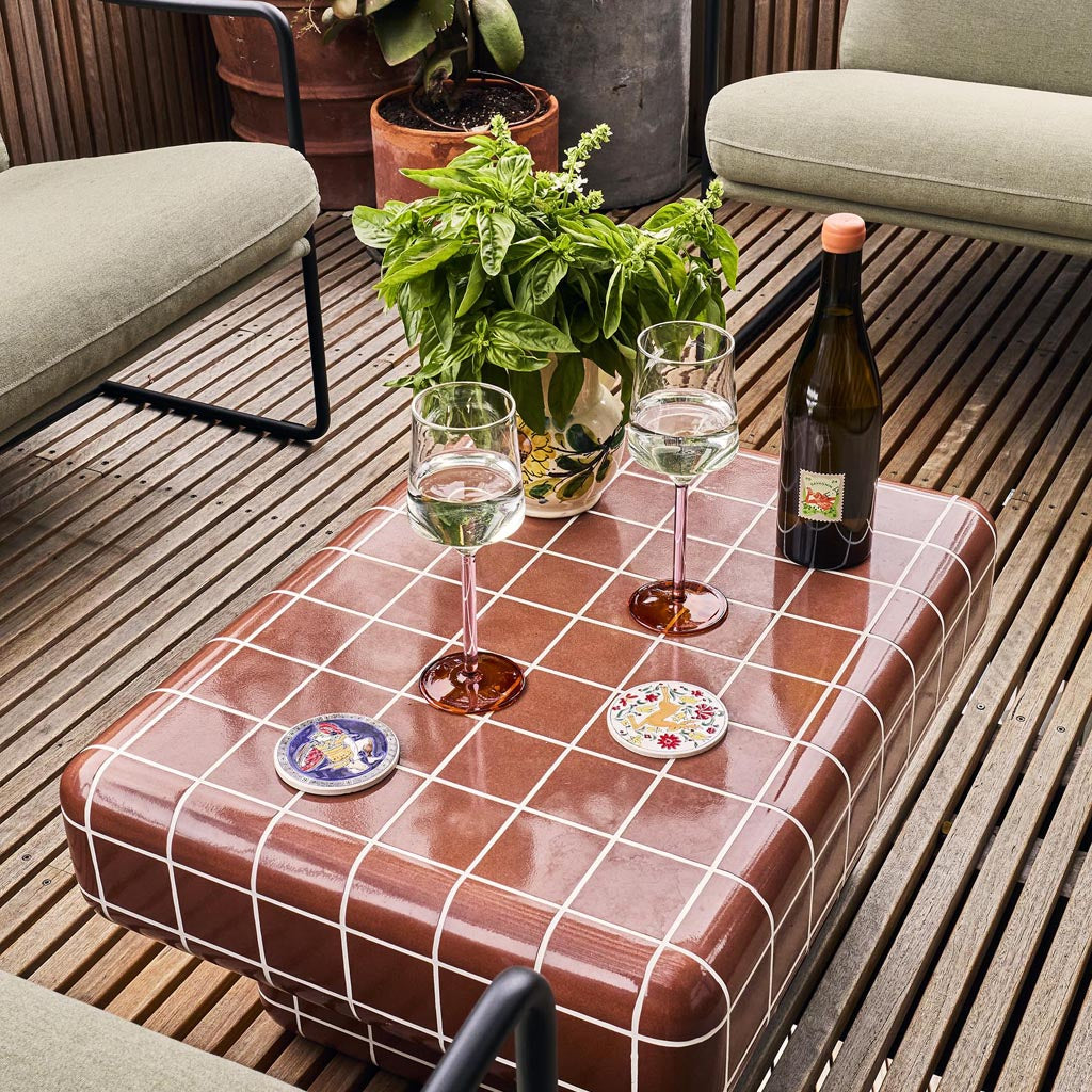 The image shows a set of two wine glasses from Kip & Co, part of their Marshmallow and Marmalade collection. The glasses are elegantly designed with a unique, artistic flair. Each glass features a colorful, abstract pattern that resembles a blend of pastel hues, reminiscent of marshmallows and marmalade. The glasses are set against a plain background, highlighting their vibrant design and sophisticated shape.